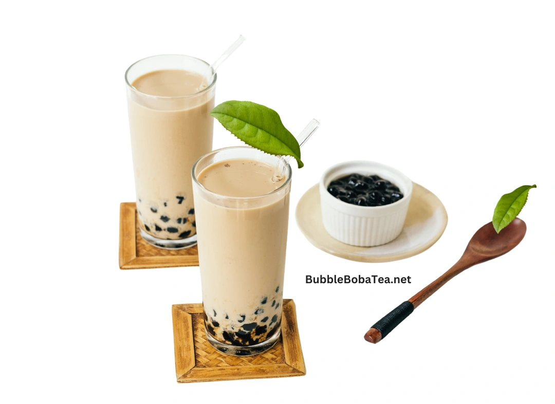 Two glasses of bubble tea with tapioca pearls, topped with fresh tea leaves, alongside a small bowl of boba pearls and a wooden spoon and url of the site privacy policy page.